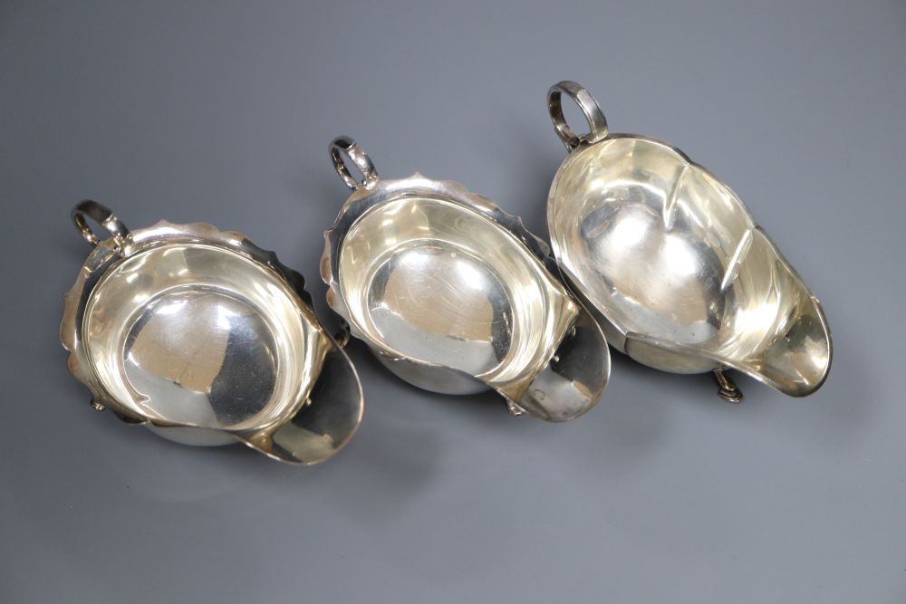 A pair of George V silver sauceboats, Barker Brothers, Chester, 1925 and one other earlier sauceboat,